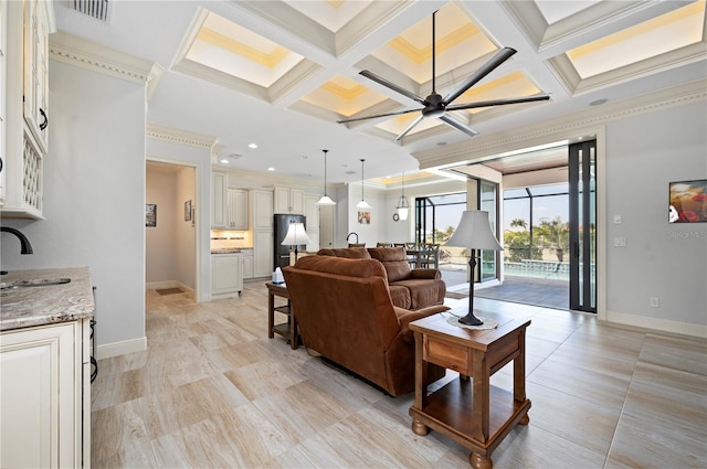 tiled living room featuring coffered ceiling, beam ceiling, ceiling fan, crown molding, and sink