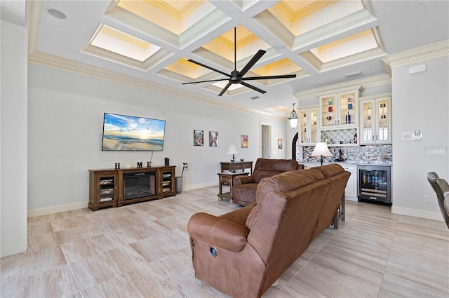 living room with coffered ceiling, wine cooler, ornamental molding, and ceiling fan