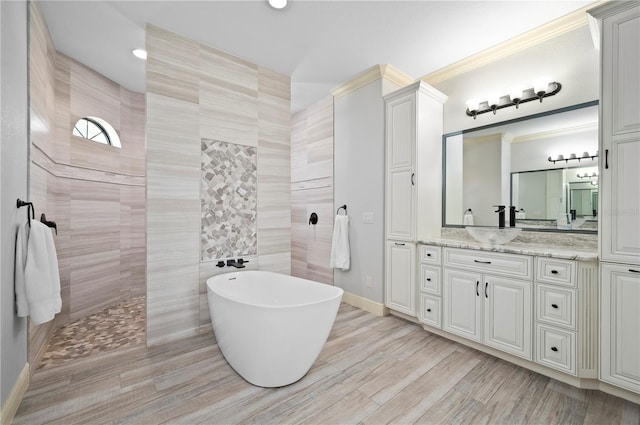 bathroom featuring tile walls, shower with separate bathtub, ornamental molding, and vanity