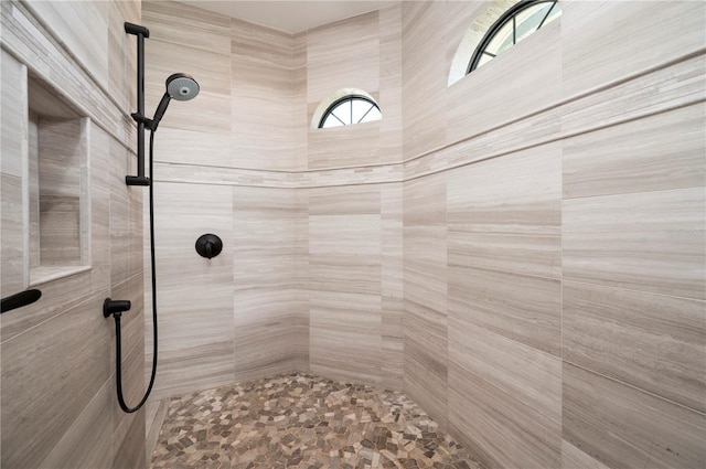 bathroom with a tile shower