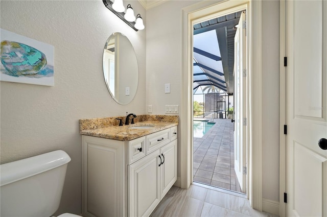 bathroom with tile floors, toilet, and vanity