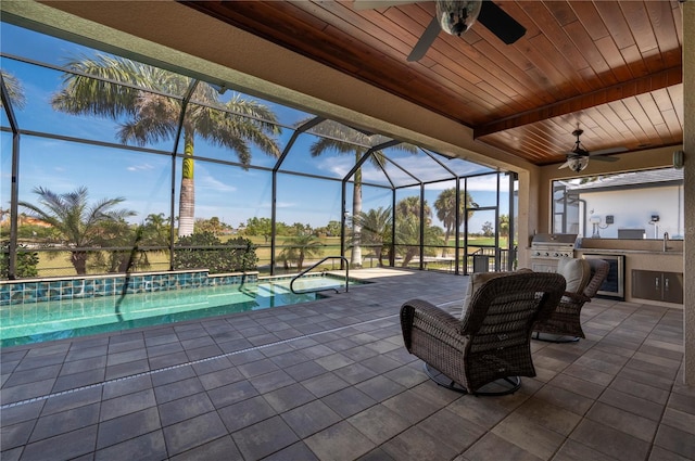 unfurnished sunroom featuring ceiling fan and wood ceiling