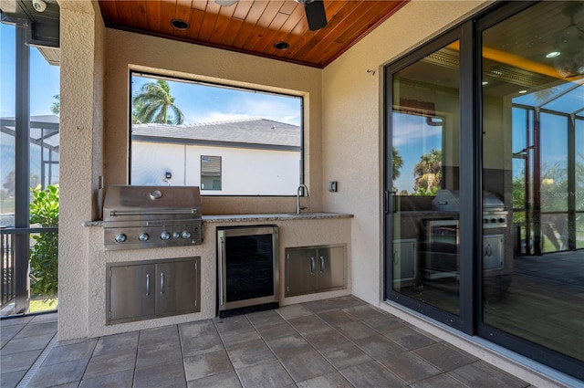 view of patio featuring area for grilling, sink, and wine cooler