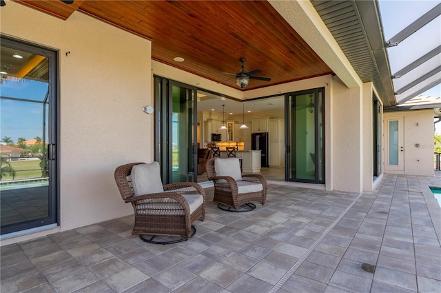 view of terrace with an outdoor living space and ceiling fan