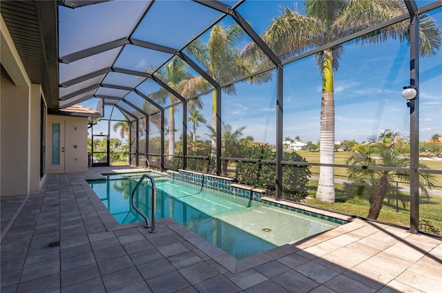 view of swimming pool featuring a lanai and a patio area