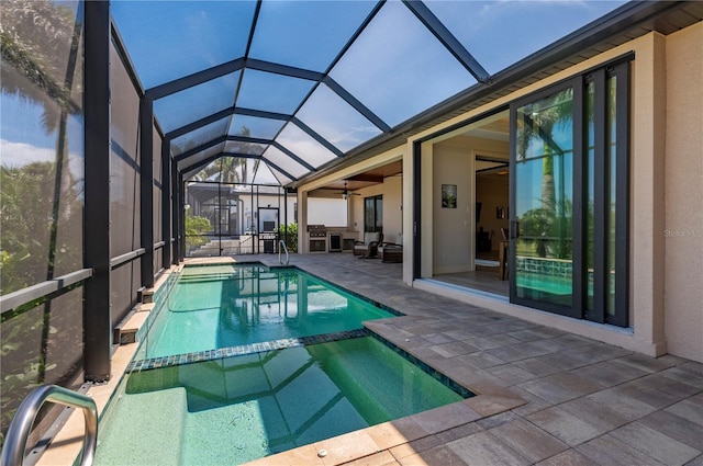 view of swimming pool featuring a patio, ceiling fan, and glass enclosure