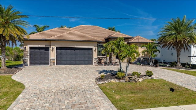 view of front of property with a front yard and a garage