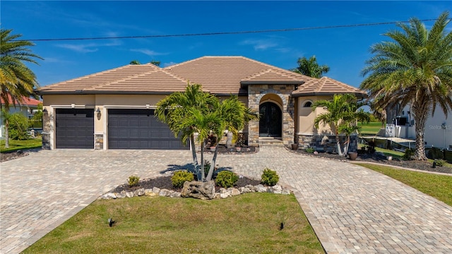 view of front of property with a front lawn and a garage