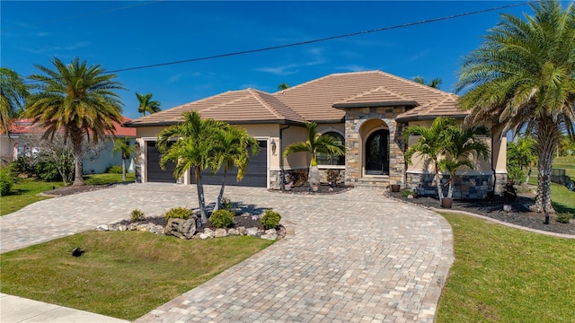 mediterranean / spanish house with a front lawn and a garage