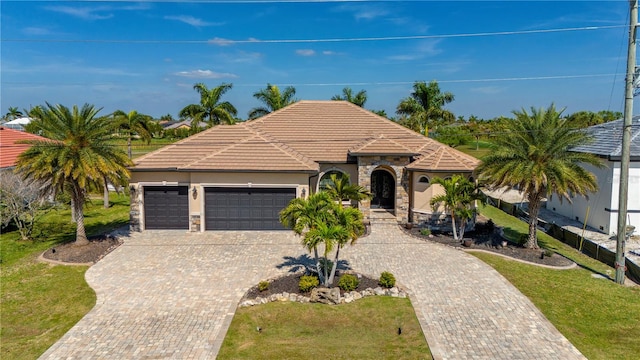 view of front of property with a front lawn and a garage