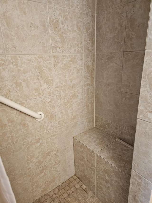 bathroom with a tile shower