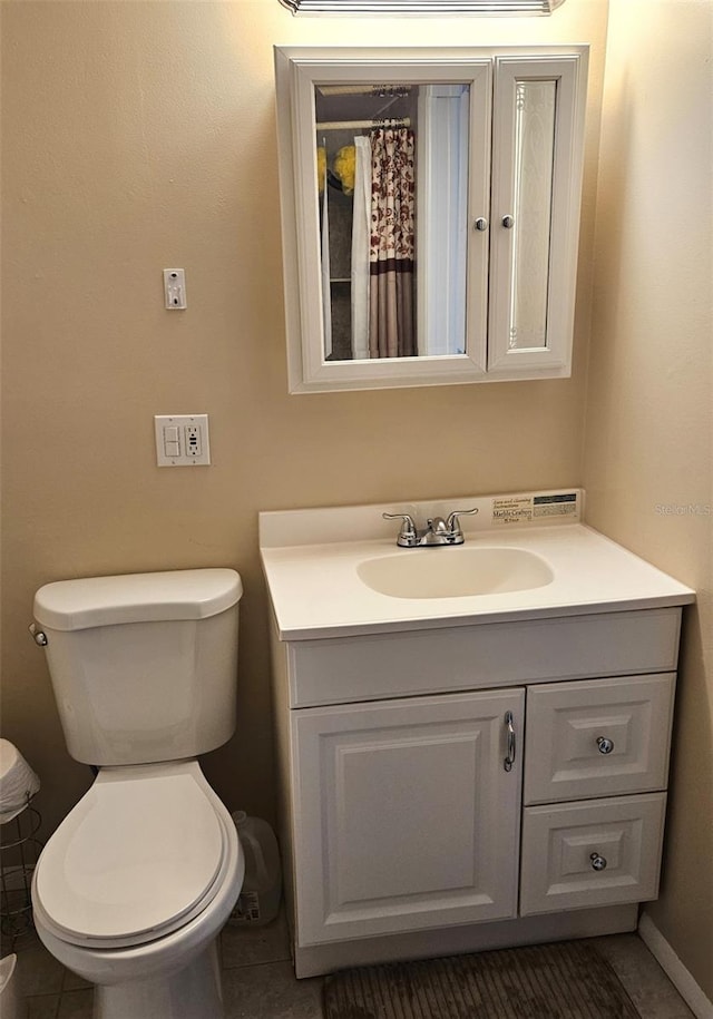 bathroom with tile patterned floors, toilet, and vanity