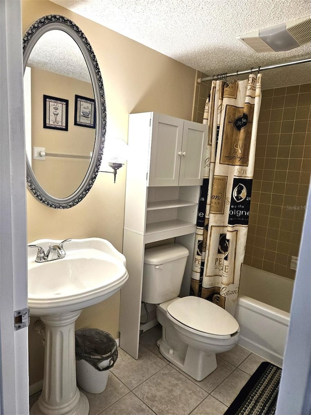 bathroom with a textured ceiling, tile patterned floors, toilet, and shower / bath combination with curtain