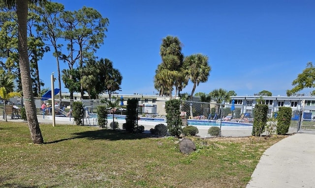 view of swimming pool with a lawn