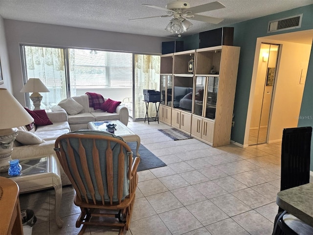 21280 Brinson Ave Unit 205, Port Charlotte, FL 33952 - living room featuring light tile patterned floors, visible vents, a textured ceiling, and ceiling fan