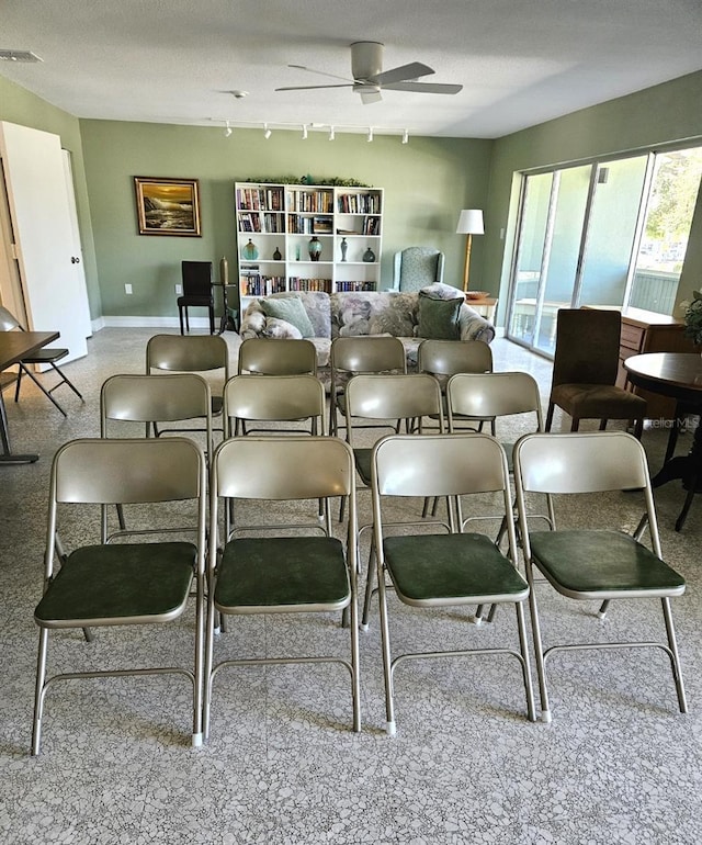 21280 Brinson Ave Unit 205, Port Charlotte, FL 33952 - carpeted dining area featuring baseboards, visible vents, ceiling fan, track lighting, and a textured ceiling