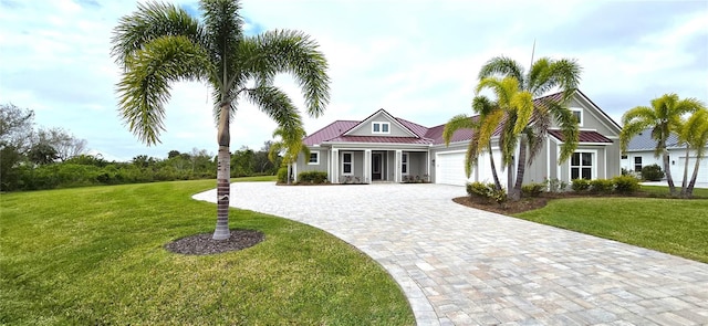 view of front of house featuring a front lawn and a garage