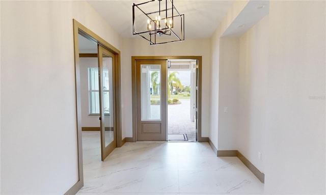 tiled entryway with an inviting chandelier