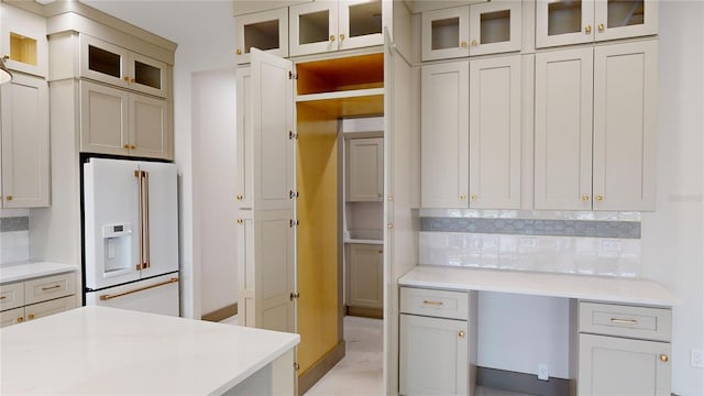 kitchen featuring high end white refrigerator, tasteful backsplash, and light hardwood / wood-style floors