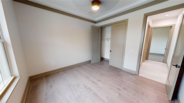 unfurnished bedroom featuring light hardwood / wood-style floors and a closet