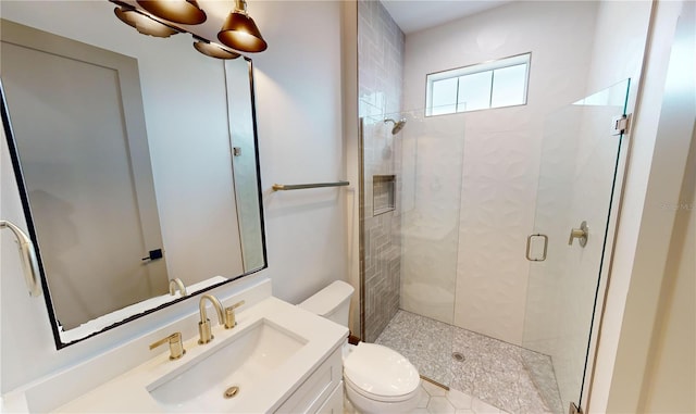 bathroom featuring an enclosed shower, vanity, and toilet