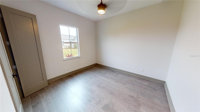 empty room with light hardwood / wood-style floors and ceiling fan