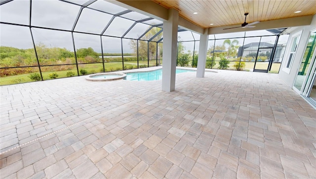 view of pool featuring an in ground hot tub, a lanai, ceiling fan, and a patio