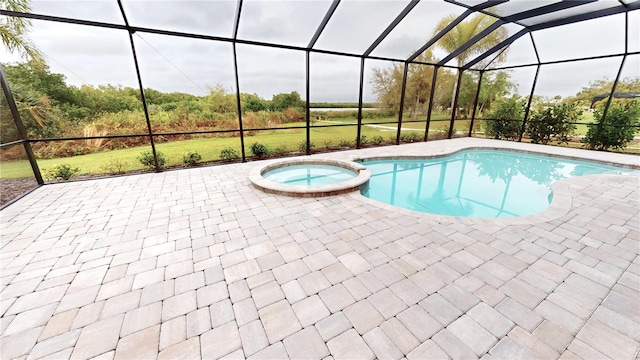 view of swimming pool with a patio area, an in ground hot tub, and a lanai