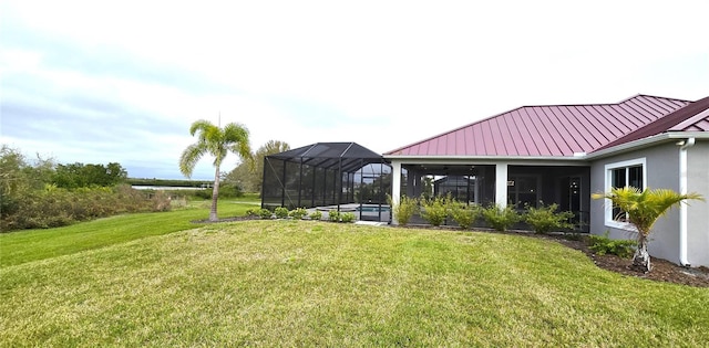 view of yard with a swimming pool and a lanai