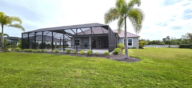 back of house with a lawn, a patio area, and a lanai