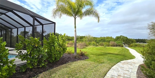 view of yard with glass enclosure