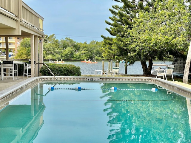 view of swimming pool with a water view