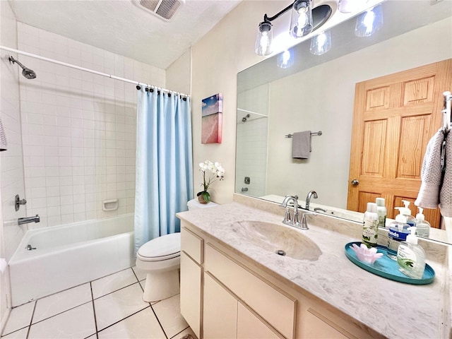 full bathroom featuring tile patterned floors, toilet, shower / tub combo with curtain, vanity, and a textured ceiling