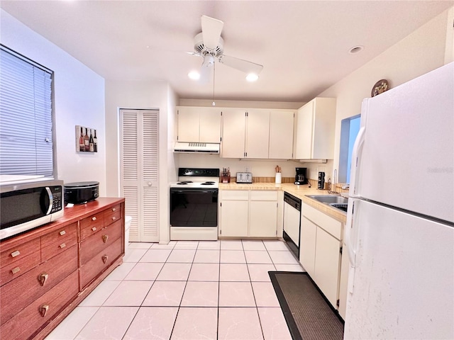 kitchen with white cabinets, light tile patterned floors, white appliances, sink, and ceiling fan