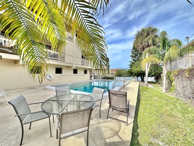 view of pool featuring a yard and a patio