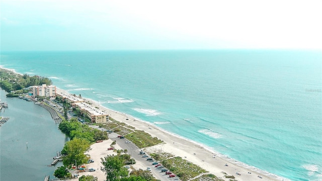 birds eye view of property featuring a water view and a beach view