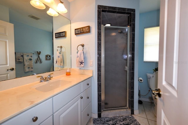 bathroom featuring tile flooring, a shower with shower door, large vanity, and toilet