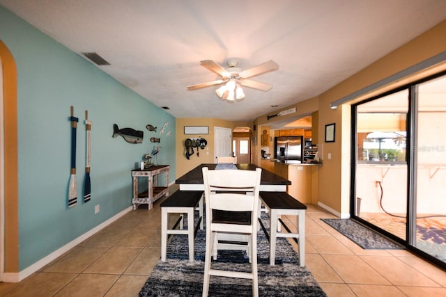 tiled dining area with ceiling fan