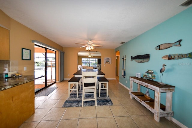 tiled dining area featuring ceiling fan