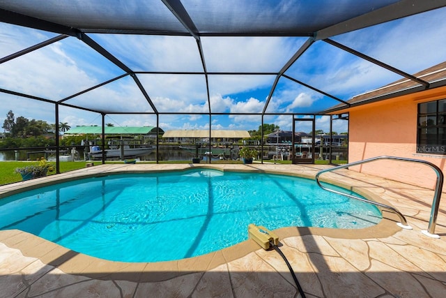 view of pool with a patio area and a lanai