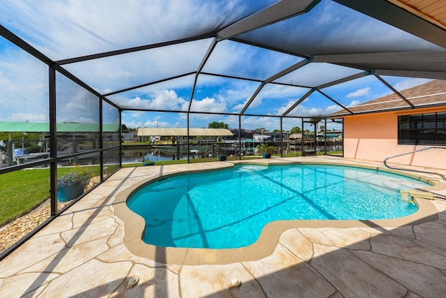 view of pool with a patio area and glass enclosure