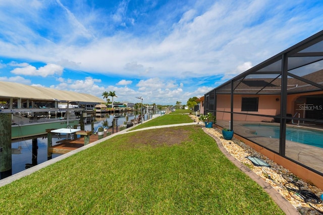 dock area featuring a lawn, glass enclosure, and a water view