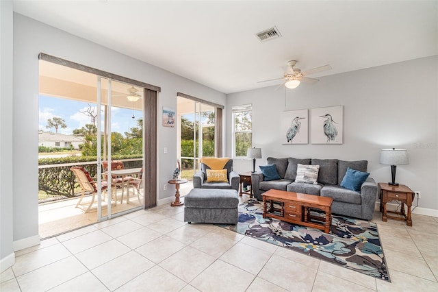 living room featuring light tile patterned floors and ceiling fan