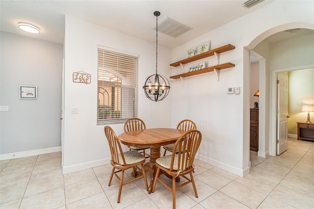 tiled dining space featuring a chandelier