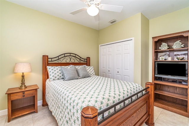 bedroom with ceiling fan, a closet, and light tile patterned floors