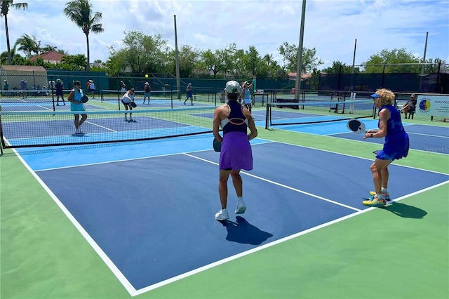 view of tennis court with basketball hoop