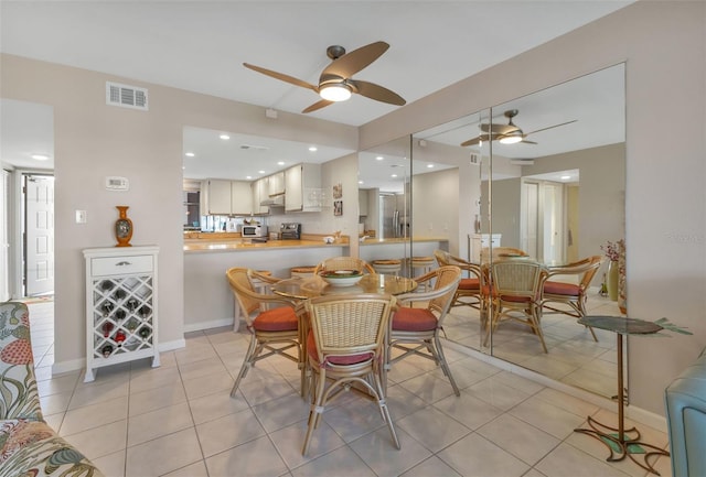 tiled dining room with ceiling fan