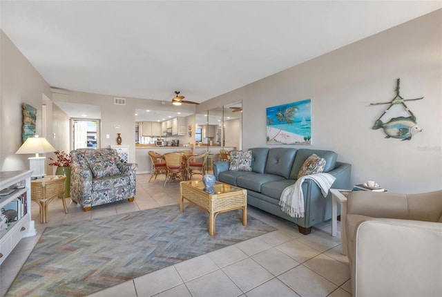 living room with light tile floors and ceiling fan