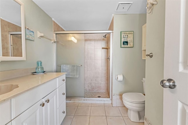 bathroom featuring toilet, tile floors, a tile shower, and vanity