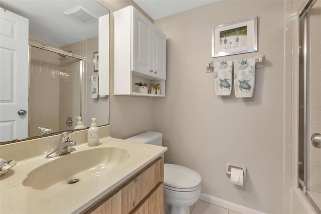 bathroom featuring vanity, tile flooring, and toilet